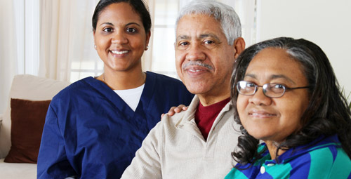 Doctor visiting a man and woman at home